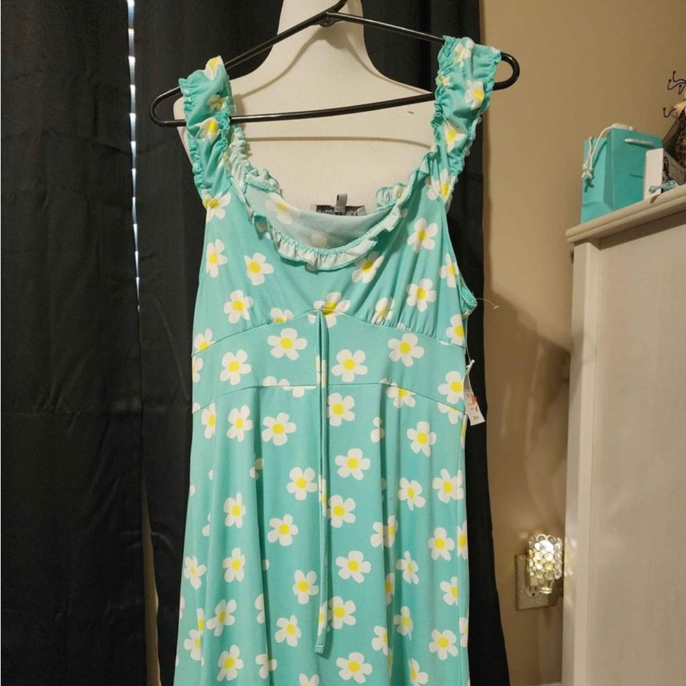 Very pretty dress and very soft fits like a large